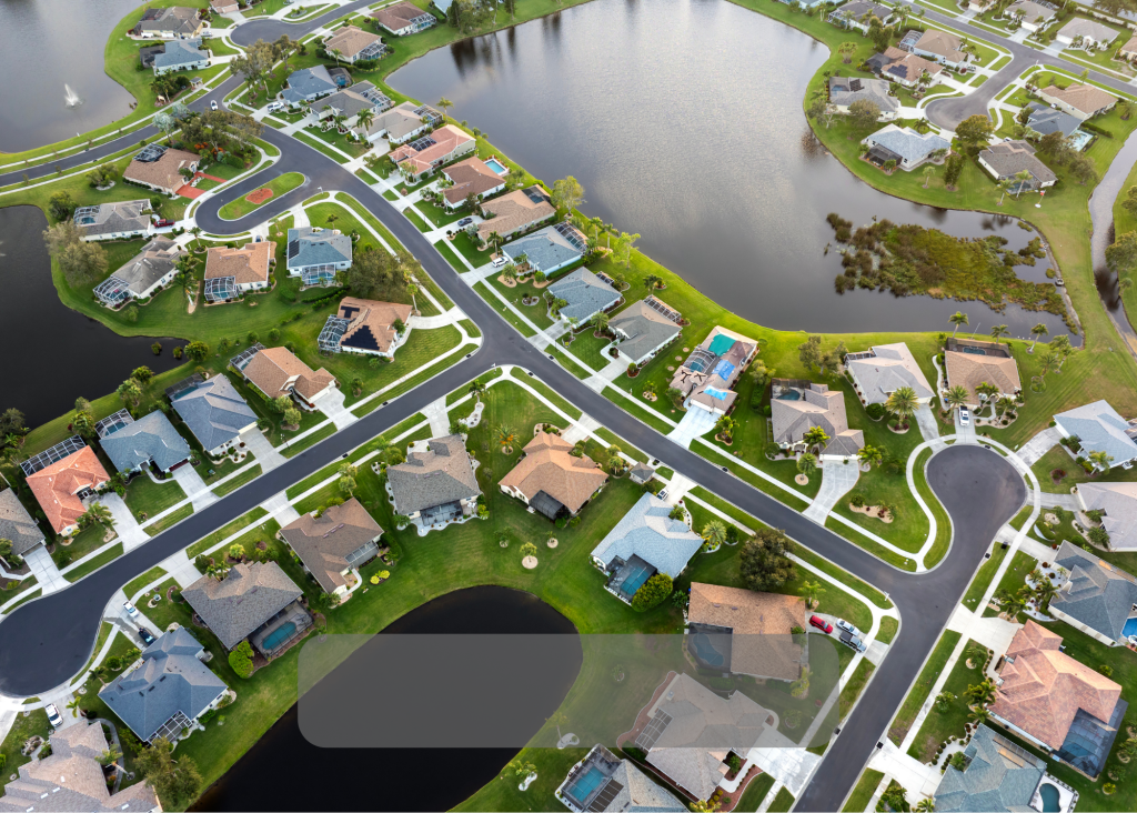 Aerial view of a residential neighborhood with curving streets and ponds